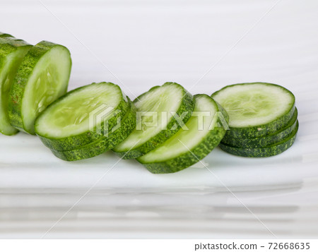 Fresh raw sliced cucumber in white background Fresh raw sliced cucumber in white background 72668635