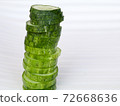 Fresh raw  sliced cucumber in white background 72668636