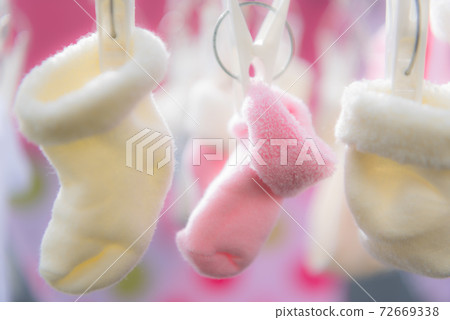 Drying newborn socks on the veranda 72669338