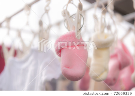 Drying newborn socks on the veranda 72669339
