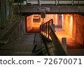 Railings and guardrails against the backdrop of a red tunnel 72670071