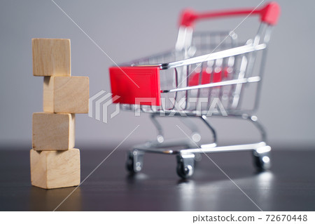 Close up shot of empty wooden blocks with shopping cart. Close up shot of empty wooden blocks with shopping cart. 72670448