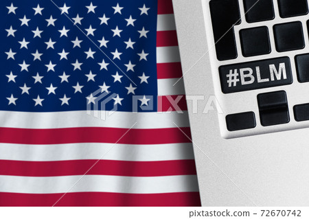Hashtag BLM on a laptop keyboard with an American flag background Hashtag BLM on a laptop keyboard with an American flag background 72670742