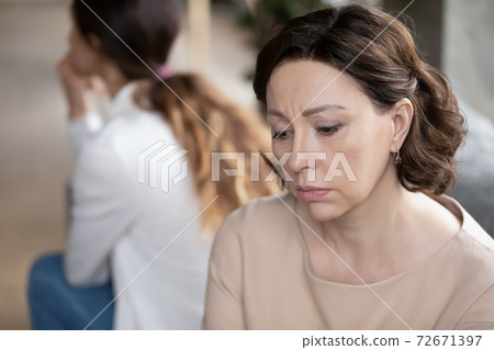 Close up upset mature mother and grownup daughter after quarrel Close up upset mature mother and grownup daughter after quarrel 72671397
