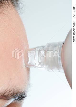 Cleaning forehead skin with remover Cleaning forehead skin with remover 72671843