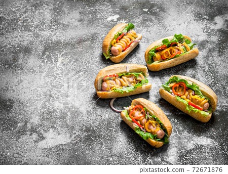 Street food. Delicious hot dogs with tomato sauce, mustard and herbs. Street food. Delicious hot dogs with tomato sauce, mustard and herbs. 72671876