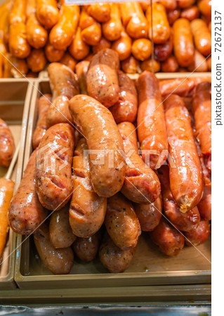 Close up photo of fried sausage at street food market 72672137