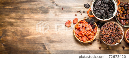 Dried fruits in bowls. 72672420
