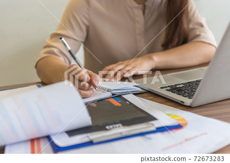 Close-up of businesswoman hand writing notes Close-up of businesswoman hand writing notes 72673283