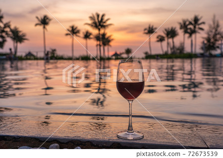 Glass of red wine at luxury beach resort Glass of red wine at luxury beach resort 72673539
