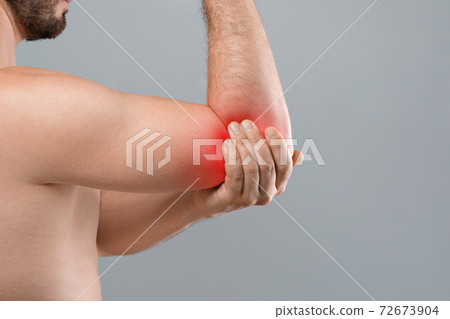 Cropped of topless man suffering from painful elbow 72673904