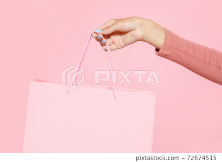 Store opening and discounts for customers. Hand of young african american lady holding pink shopping bag 72674515