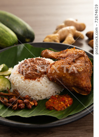 Nasi Kukus is usually comprising freshly steamed rice and crispy fried chicken 72674619