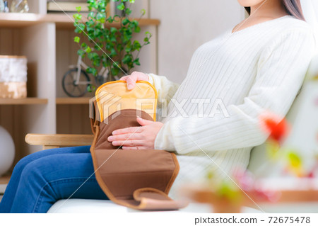 A warm female supporter belt with a hot water bottle A warm female supporter belt with a hot water bottle 72675478