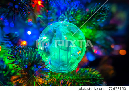 Russia. Saint-Petersburg. Christmas decoration for Christmas tree snow glowing fairy house in a glass bowl. Russia. Saint-Petersburg. Christmas decoration for Christmas tree snow glowing fairy house in a glass bowl. 72677160