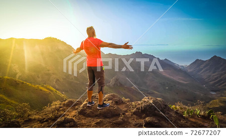 Senior man greeting sunset 72677207