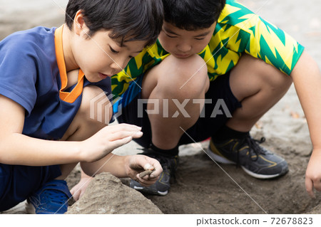 Children playing in the sandbox 72678823