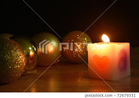 golden ball couple candle light for decoration in Christmas and new year festival in black background golden ball couple candle light for decoration in Christmas and new year festival in black background 72679331