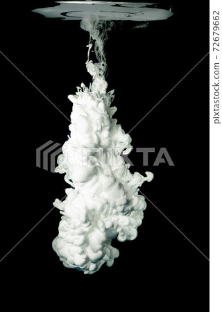White ink in water, isolated on black background. Acrylic paint splash. White ink in water, isolated on black background. Acrylic paint splash. 72679662
