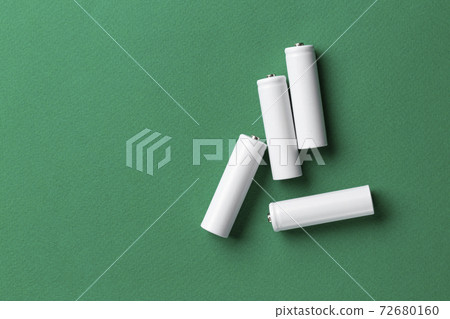 Rechargeable AAA batteries in white on a green background. Place for text. Rechargeable AAA batteries in white on a green background. Place for text. 72680160