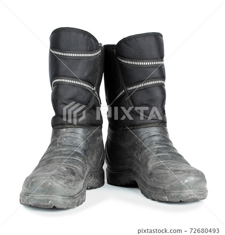 Dirty insulated old boots on a white background. Dirty insulated old boots on a white background. 72680493