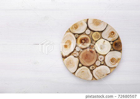 Empty round cutting board on a white wooden table. Empty round cutting board on a white wooden table. 72680507