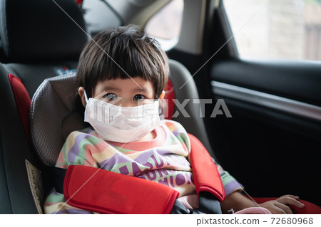 Cute baby sitting in a car safety seat Cute baby sitting in a car safety seat 72680968