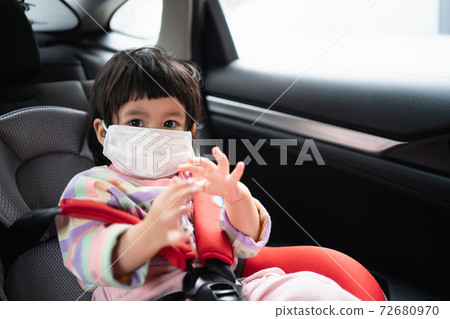Cute baby sitting in a car safety seat Cute baby sitting in a car safety seat 72680970