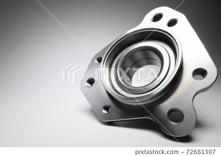 New wheel bearing in a metal housing on a black-white gradient background. New car suspension parts 72681307