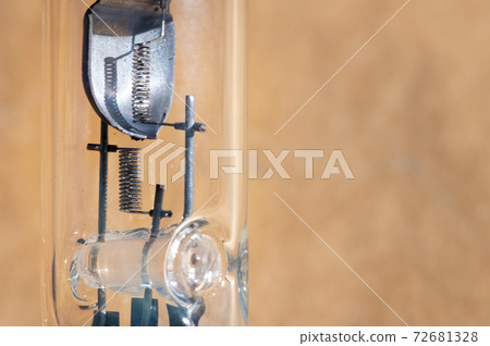 Close-up of filament H4 halogen car bulb. Close-up of filament H4 halogen car bulb. 72681328
