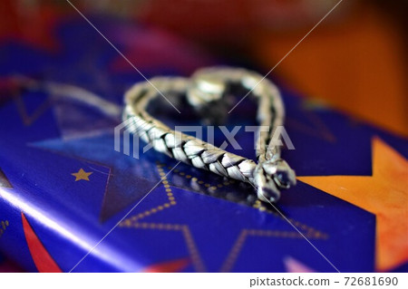 Close up of colorful christmas gifts with a silver colored heart Close up of colorful christmas gifts with a silver colored heart 72681690