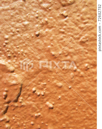 Background painted in orange on a wall 72682782