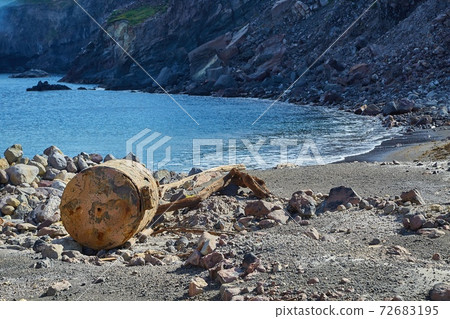 Old rusty boiler scrap metal on the shore 72683195
