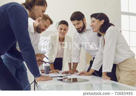 Group of young smiling office workers business people duscussing new project together in office Group of young smiling office workers business people duscussing new project together in office 72683493