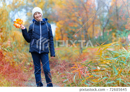 a girl posing near river and enjoys autumn, beautiful nature with yellow leaves a girl posing near river and enjoys autumn, beautiful nature with yellow leaves 72685645