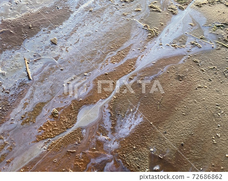 oil stains on beach sand environmental disaster 72686862