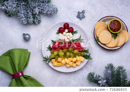 Cheese plate with salami in shape of tree. 72686933