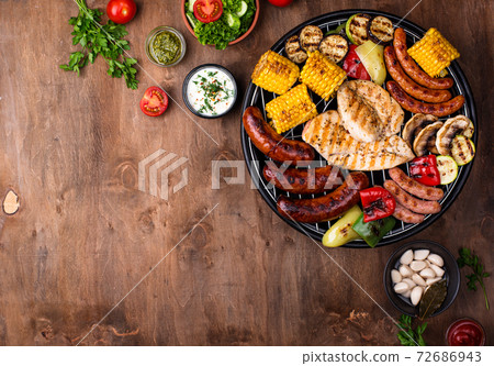Grilled sausages, meat, and vegetables. Grilled sausages, meat, and vegetables. 72686943