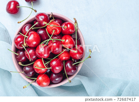 Cherry with leaf on plate and water dropsand on grey stone table Cherry with leaf on plate and water dropsand on grey stone table 72687417