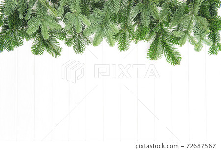 Christmas tree branches bright wooden background Undecorated evergreen twigs Christmas tree branches bright wooden background Undecorated evergreen twigs 72687567