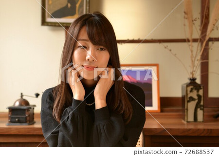 Young beautiful woman relaxing in the room Young beautiful woman relaxing in the room 72688537