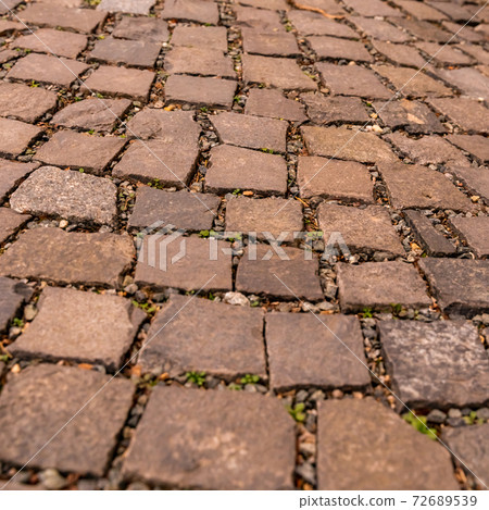 brown stone surface of cobblestones, square in European city brown stone surface of cobblestones, square in European city 72689539