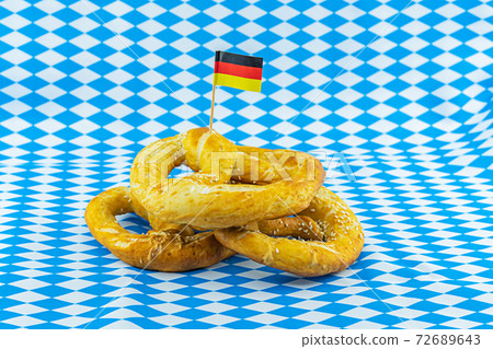 German pretzel with the flag of Germany, symbol of the Oktoberfest beer festival 72689643