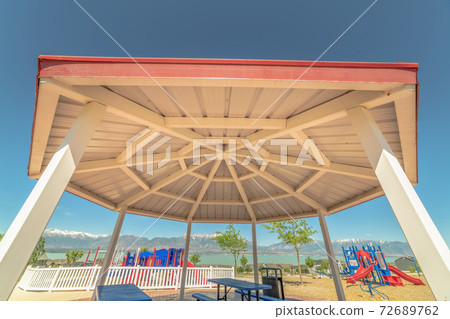 Octagon shape pavilion and playground with lake and Timpanogos mountains view 72689762