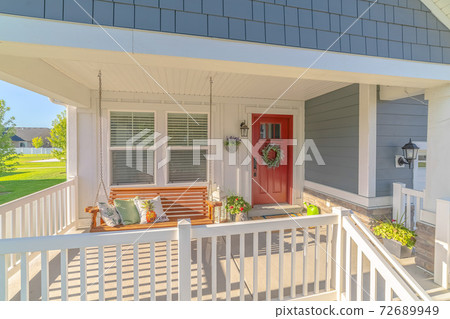 Front porch of traditional home and swinging chair Front porch of traditional home and swinging chair 72689949