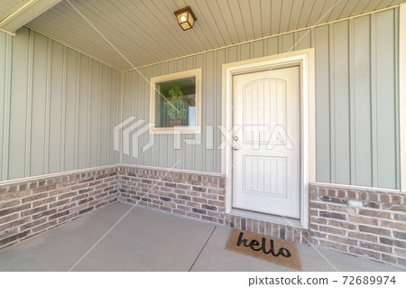 Front door and veranda of home with welcome mat Front door and veranda of home with welcome mat 72689974