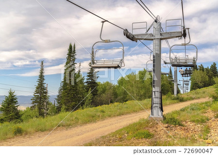 Focus on chairlifts with scenic aerial view of Park City Utah during off season 72690047