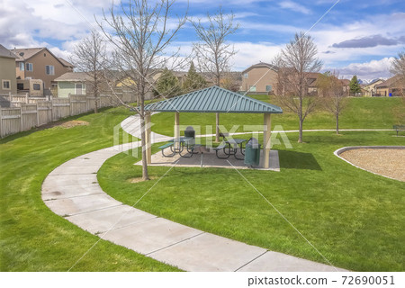 Small picnic area and curving pathways on a park covered with vivid grasses Small picnic area and curving pathways on a park covered with vivid grasses 72690051