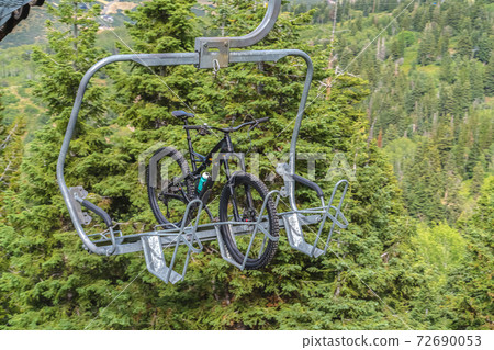 Lift accessed mountain biking with bikes on chairlifts in Park City in summer Lift accessed mountain biking with bikes on chairlifts in Park City in summer 72690053