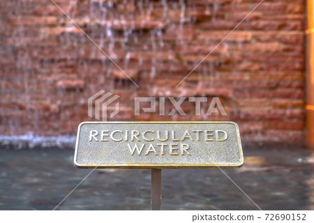 Close up of metal plate with words Recirculated Water embossed on surface Close up of metal plate with words Recirculated Water embossed on surface 72690152